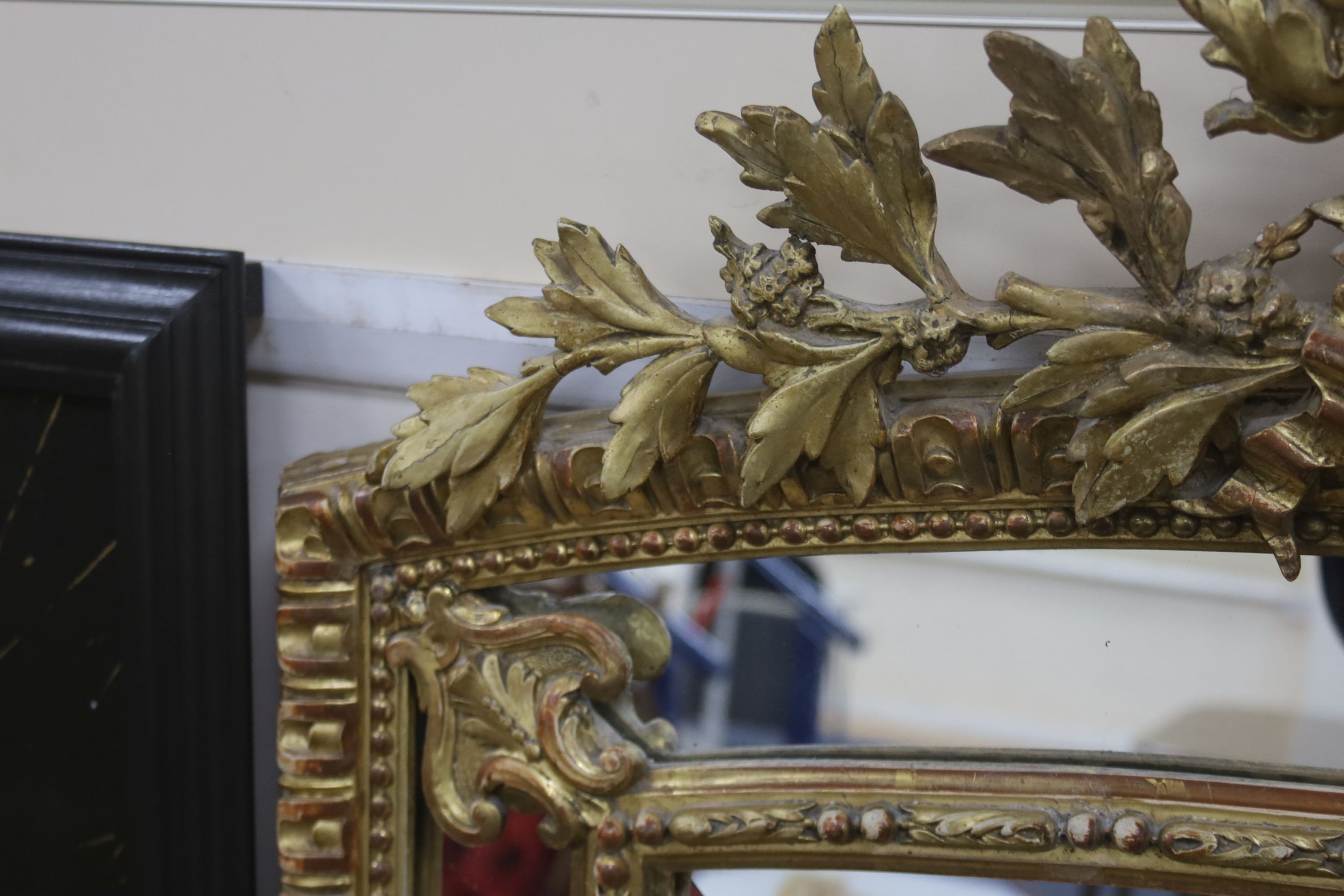 A 19th century giltwood and gesso overmantel mirror with Olympic Torch & Laurel Crown, side cushions with decorated bead detail, width 92cm, height 153cm